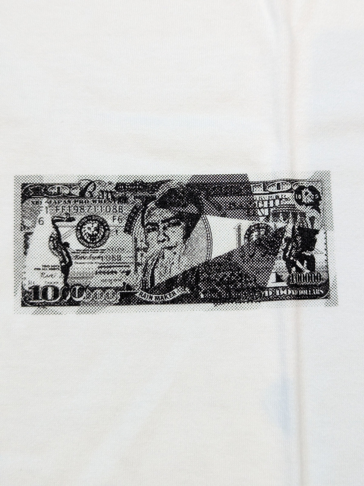 オカダ・カズチカ「RAINMAKER DOLLAR HISTORY」Tシャツ(ホワイト)